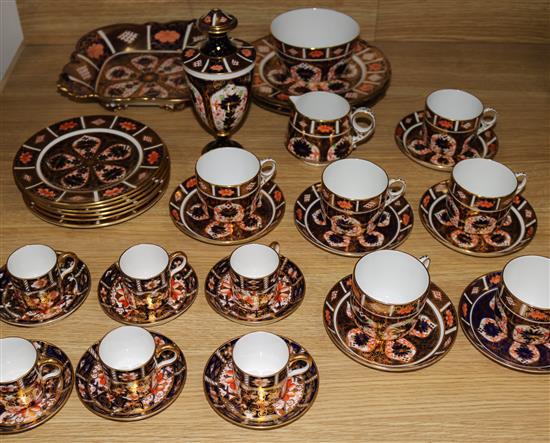A Royal Crown Derby Imari pattern tea set for six, six coffee cans and saucers, three plates, a vase and cover